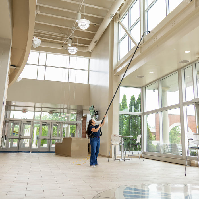 Ground-level high dusting of a lobby ledge with a GoHigh kit and corded backpack